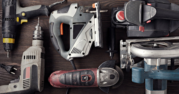 Assorted power tools on a bench