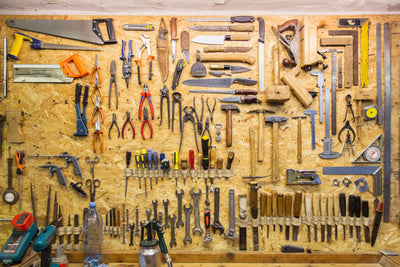 Collection of hand tools on a wooden shadow board