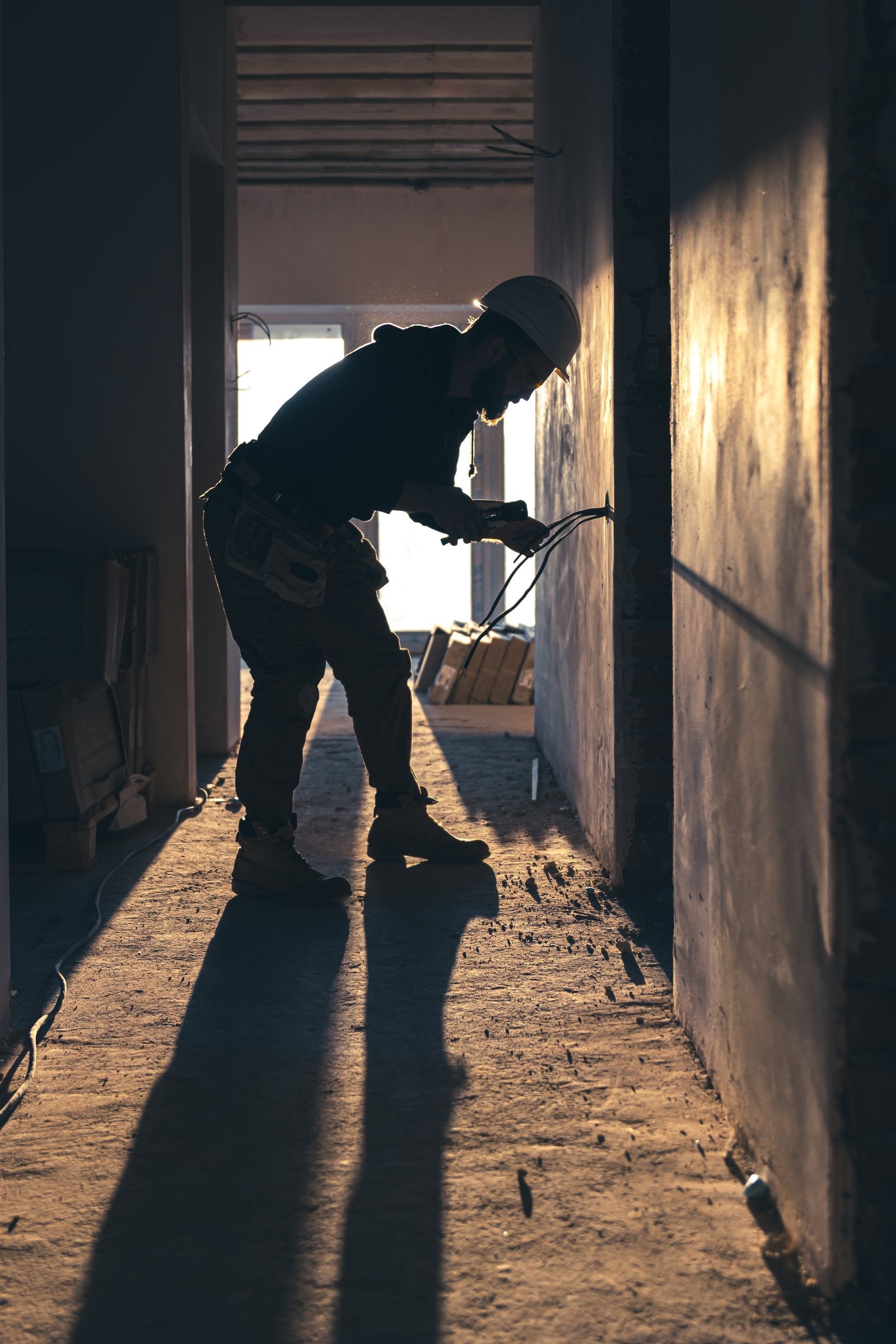 Worker cutting wires with lineman's pliers